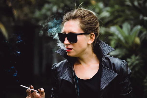 Beautiful woman smokes a cigarette.