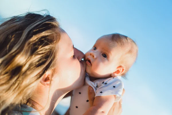 Mother with her baby on the beach — Stock Photo, Image