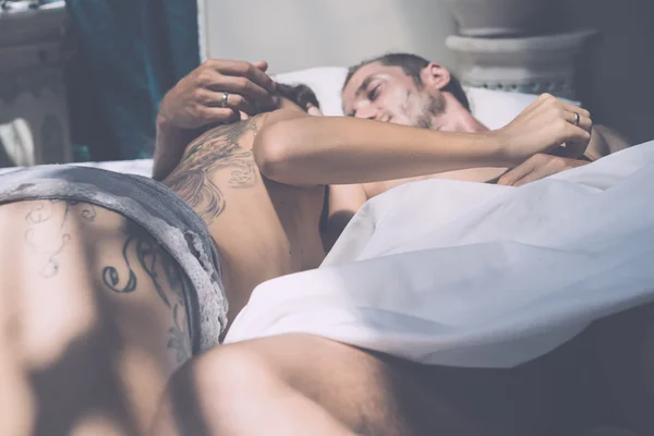 Hombre y mujer por la mañana en la cama — Foto de Stock