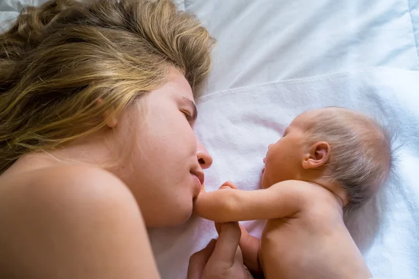 Mom gently looking at her newborn baby — Stock Photo, Image