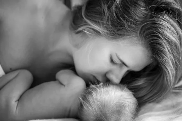 Mom gently kissisng newborn baby — Stock Photo, Image