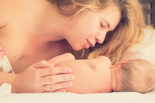 Mom gently looking at her newborn baby — Stock Photo, Image