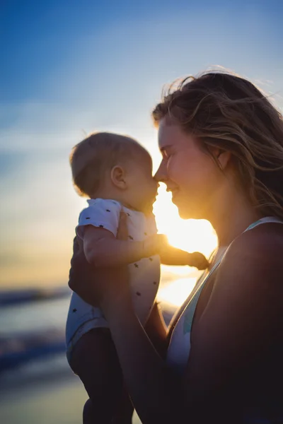 Mother with her baby on the beach — Stock Photo, Image