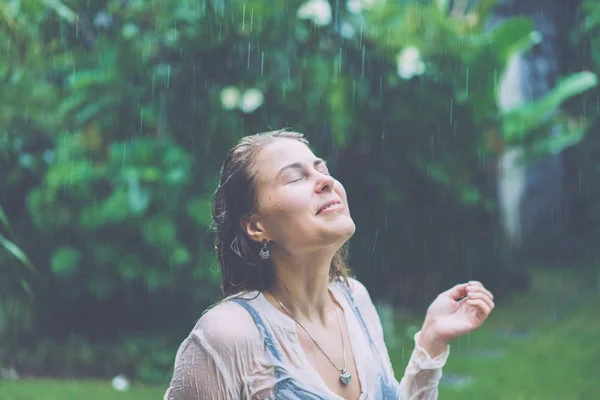 Beautiful girl standing at tropical rain Royalty Free Stock Photos