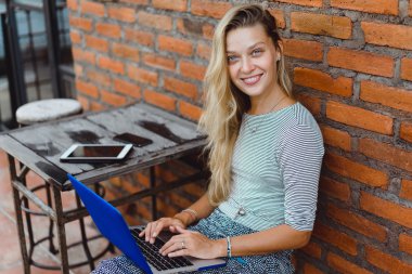 Dizüstü bilgisayar kullanan serbest çalışan kadın.