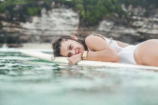 beautiful girl in the ocean Surf in the rain