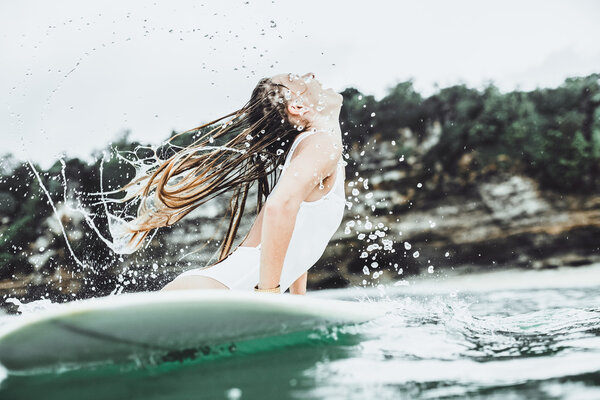 beautiful girl in the ocean Surf in the rain