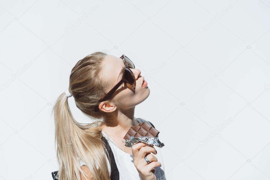 teenage girl eating chocolate bar