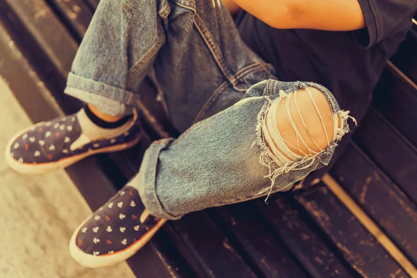 Young hipster boy sitting on the bench — Stock Photo, Image