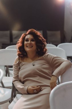 young beautiful woman singer on stage in the spotlight