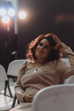 young beautiful woman singer on stage in the spotlight