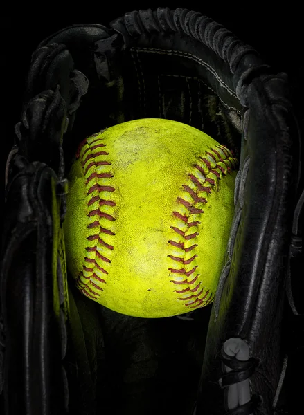 Old softball in a glove — Stock Photo, Image
