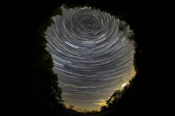 Fisheye view of  star trail of the night sky with stars rotating around polar star