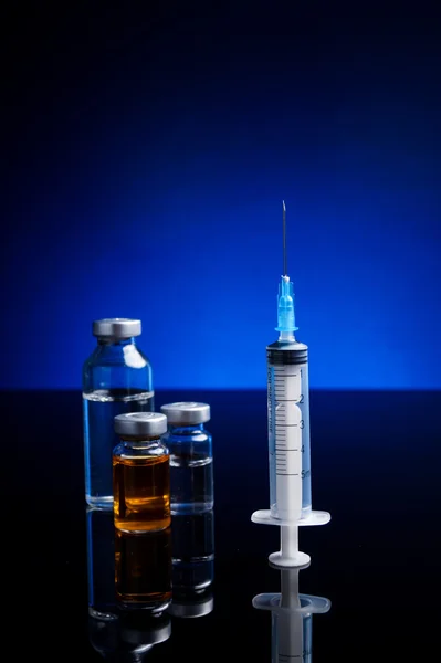 Syringe and medical vials — Stock Photo, Image