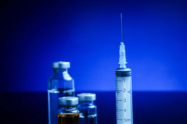 Syringe and medical vials — Stock Photo, Image