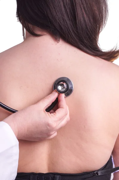 Young woman being exam for pneumonia by her family doctor — Stock Photo, Image