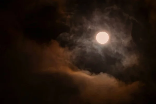Full Moon Over Dark Black Sky Stock Photo