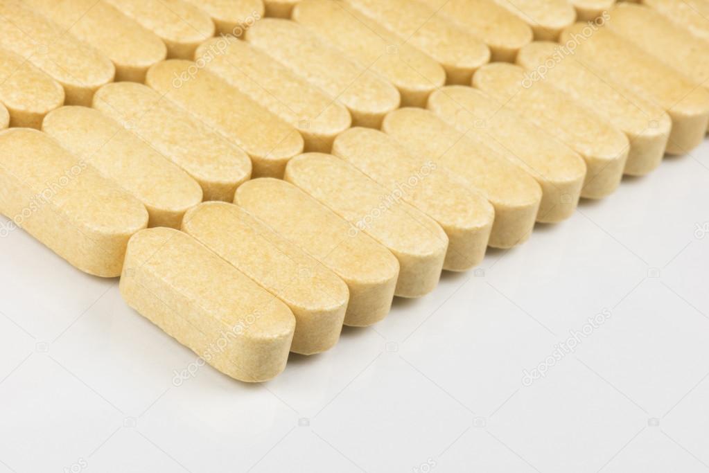 Vitamin tablets in a row