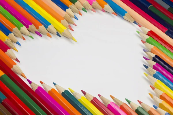 Crayons in heart shape as background picture — Stock Photo, Image