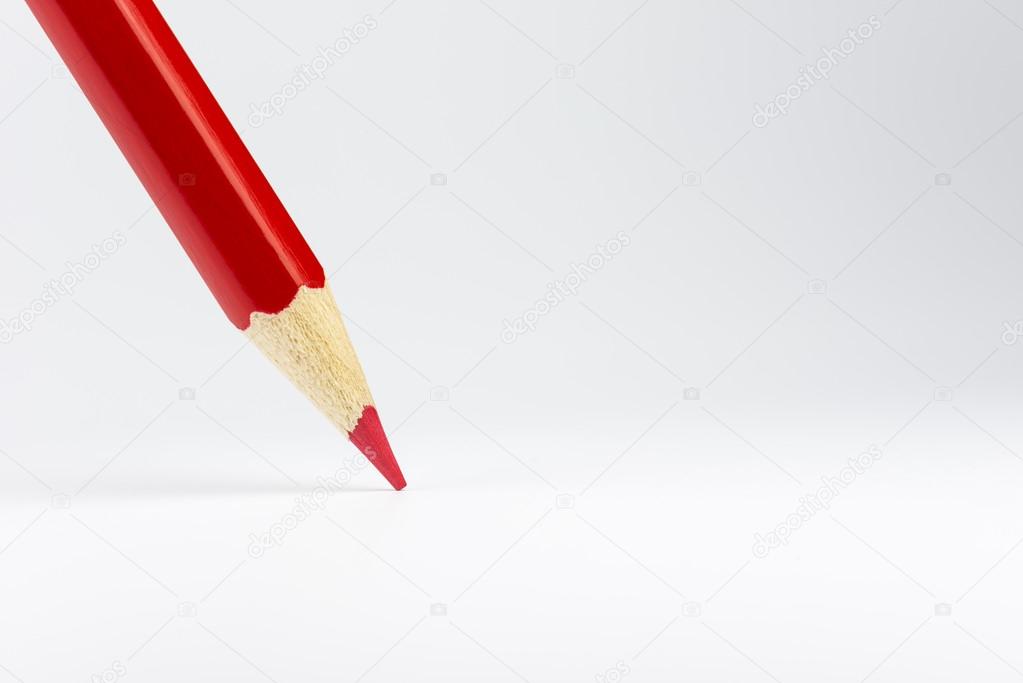 Standing red colored pencil on a white backgroun
