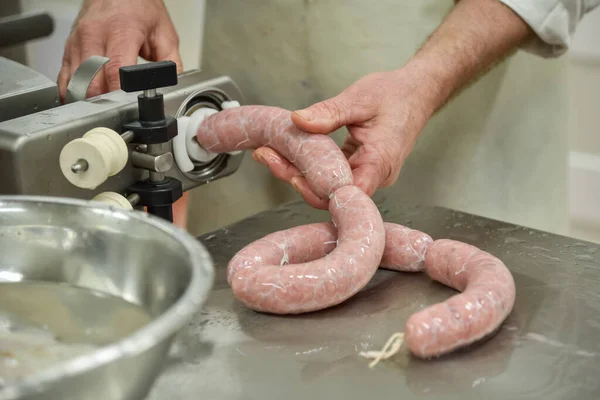 Close-up of industrial sausages production process in protective atmosphere