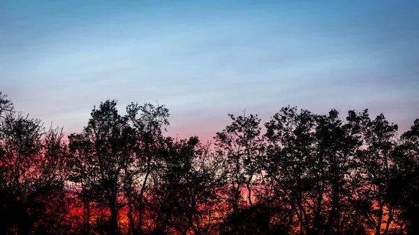 Red sunset in Ohio over a farm
