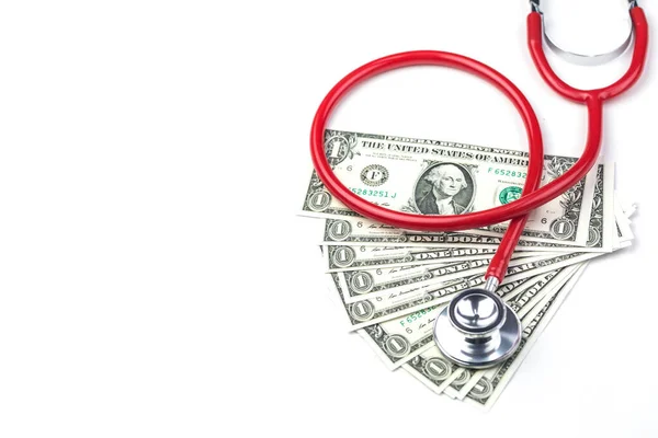 Red stethoscope with dollar money on white background