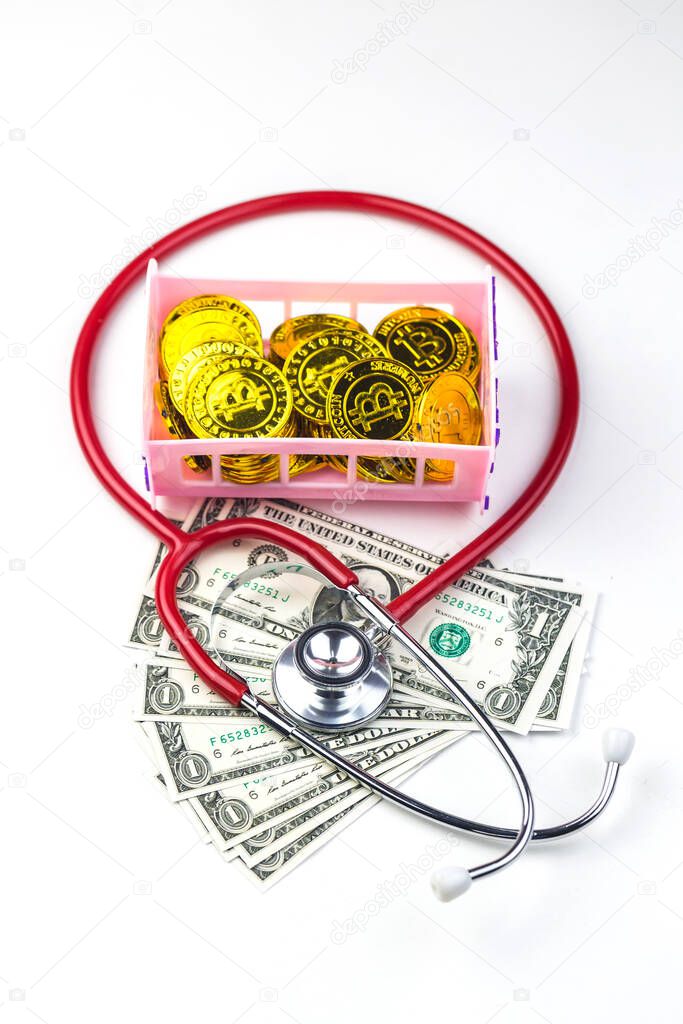 Red stethoscope with bitcoin and dollar money on white backgroun