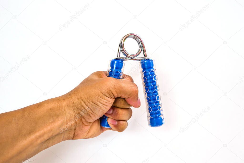 Closeup of man's hand squeezing hand coil exercise equipment on 
