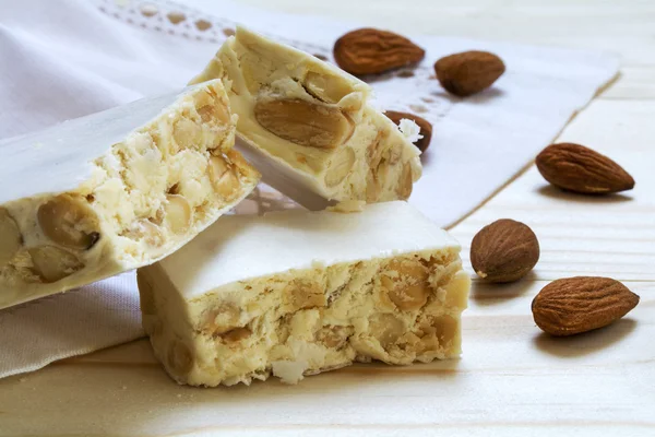 Italian festive torrone or white nougat with almonds, close up — Stock Photo, Image