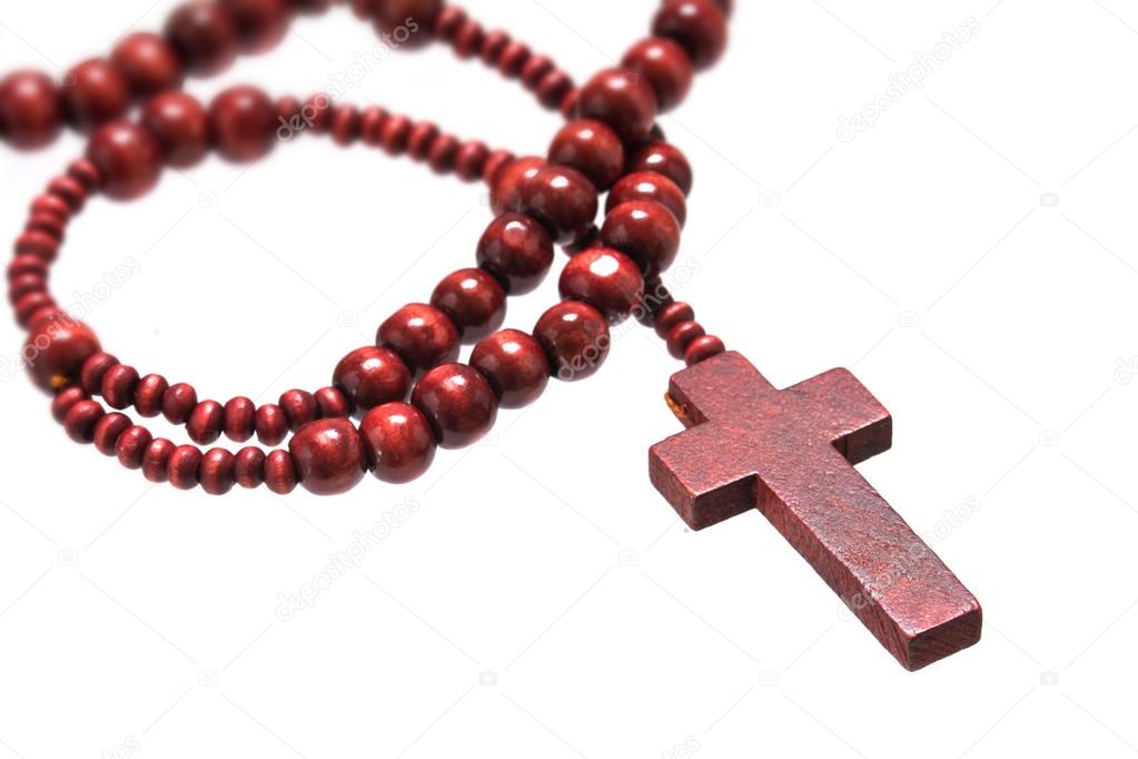 rosary beads with cross made of red wood isolated on a white background