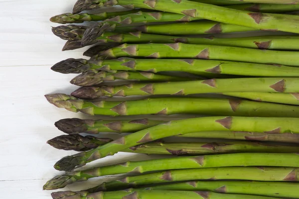 Green asparagus on white wood as background texture — Stock Photo, Image