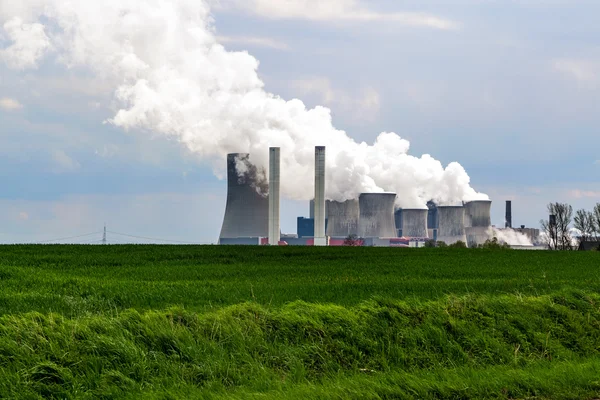 Lignite fired power station behind a agricultural field landscap Royalty Free Stock Images