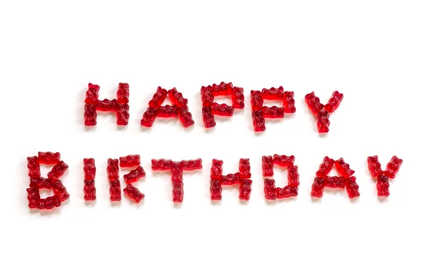 Feliz cumpleaños, cartas hechas de ositos de goma roja sobre un fondo blanco — Foto de Stock