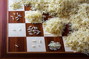 chessboard with expotential growing heaps of rice grains, concept of unlimited growth clipart