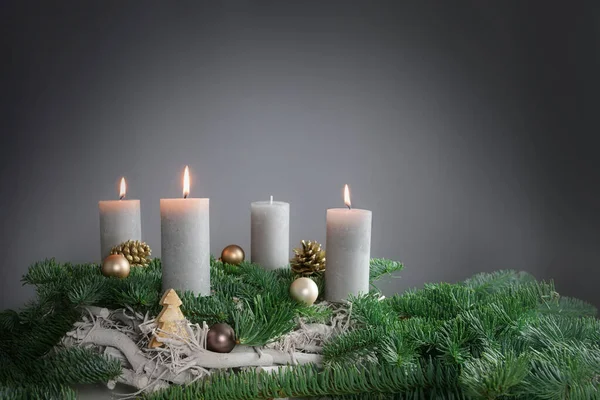 四支蜡烛中的三支正在为杉树枝条上的第三女修道院燃着 在灰色的背景下装饰圣诞装饰 复制空间 选定的焦点 狭窄的田野深度 — 图库照片