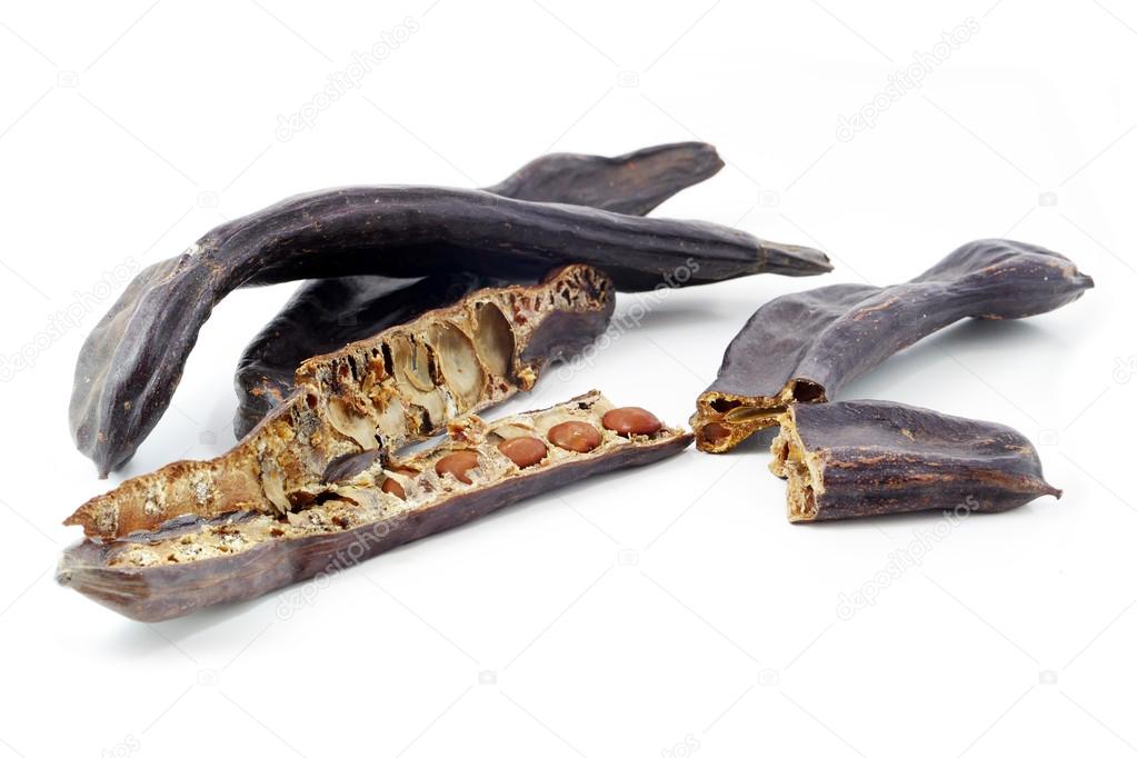 group of carob pods or St. John's bread with seeds, isolated on 