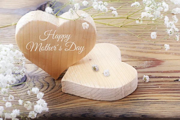 Two hearts on old wood, message happy mothers day — Stock Photo, Image