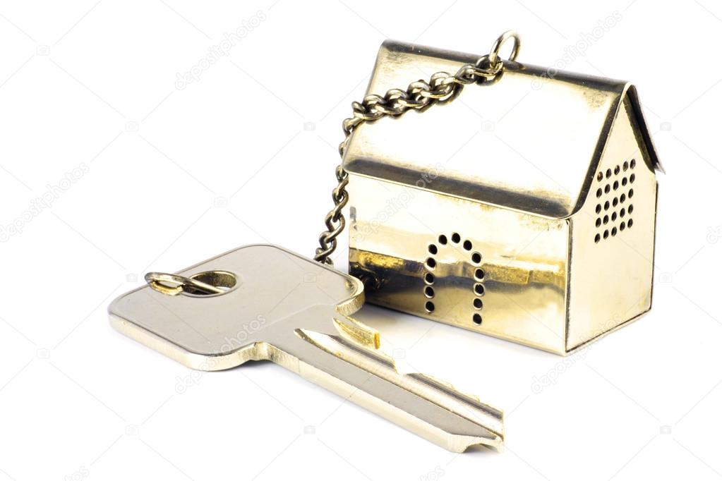 house key with a golden model house as keychain, isolated on whi