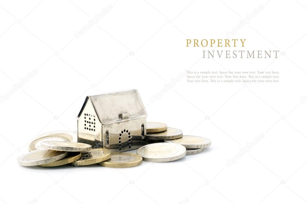 property investment, silver golden house model on coins isolated