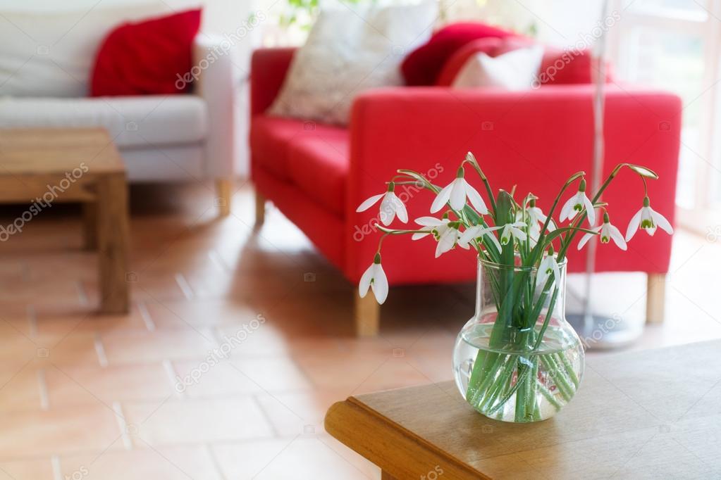 vase with snowdrops on a table in the living room