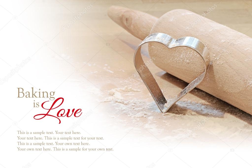 baking background, heart cookie cutter and rolling pin, blurred 