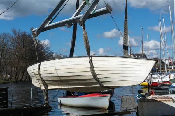 Grue bateau soulève le bateau dans l'eau — Photo