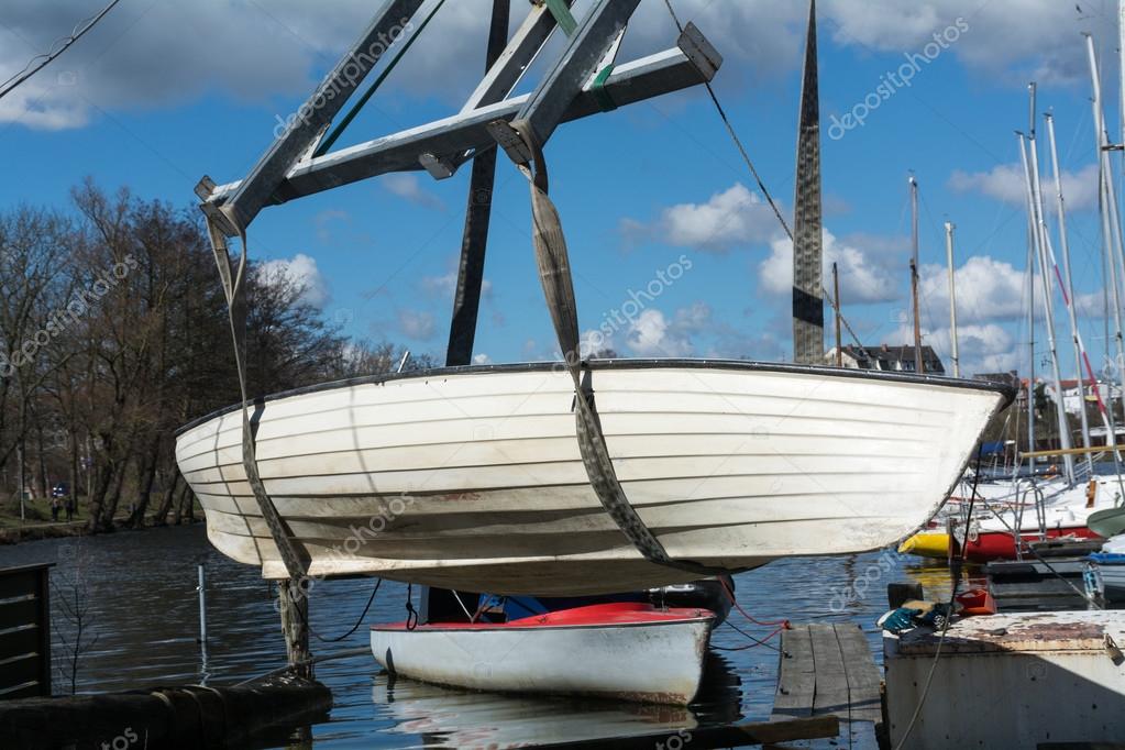 Boat crane lifts the boat into the water Stock Photo by ©fermate 69797543