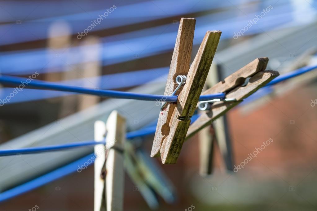 Wooden clothespins on a washing line, close up — Stock Photo © fermate