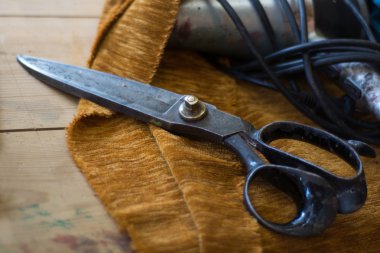 old tailor scissors in a upholstery manufactory clipart
