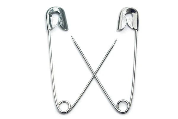 Two safety pins cross their arms, isolated on white — Stock Photo, Image
