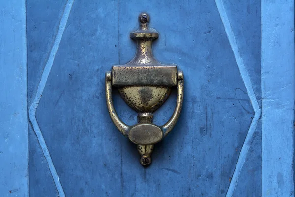 Old doorknocker from brass on a blue  door — Stock Photo, Image
