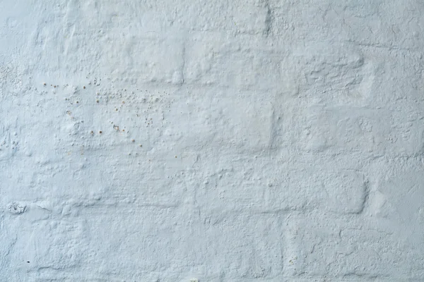 Bakgrunden konsistens, vit gips på en gammal brickwall — Stockfoto