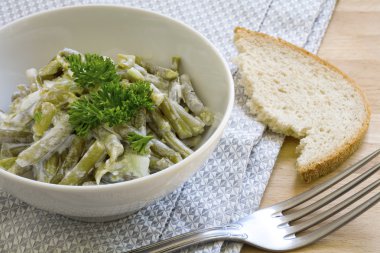 salad of green beans with sour cream dressing and parsley garnis clipart